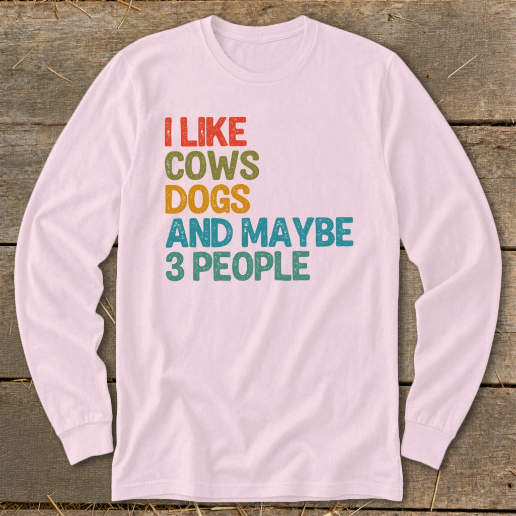 Pink long-sleeve shirt with text "I LIKE COWS DOGS AND MAYBE 3 PEOPLE".