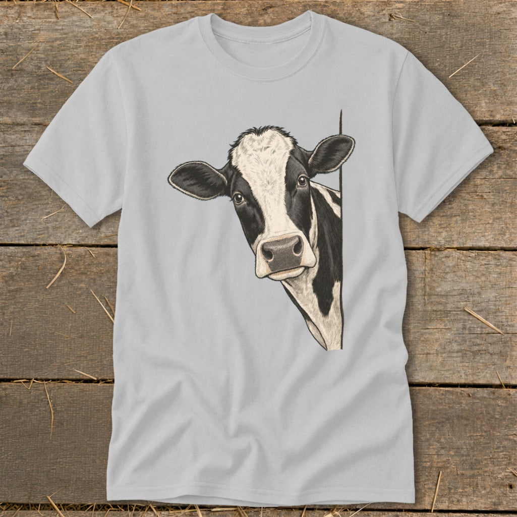 Black and white cow peeking around a corner on a grey t-shirt.