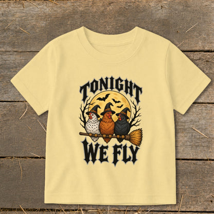 Three chickens in witch hats ride a broom with "Tonight We Fly" text.