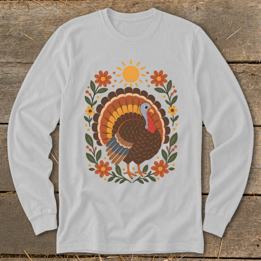 Long sleeve t-shirt with a graphic of a turkey surrounded by flowers and a sun.