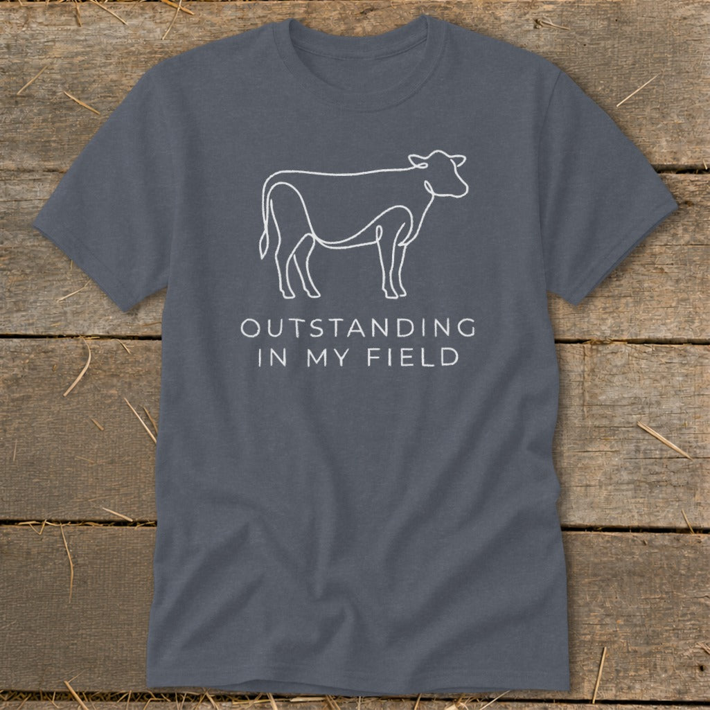 Gray t-shirt with white line art cow and text "OUTSTANDING IN MY FIELD".