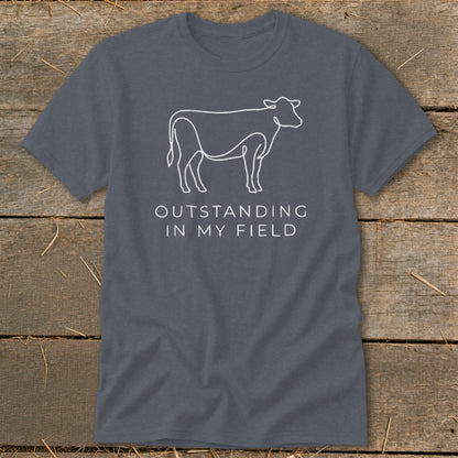 Gray t-shirt with white line art cow and text "OUTSTANDING IN MY FIELD".