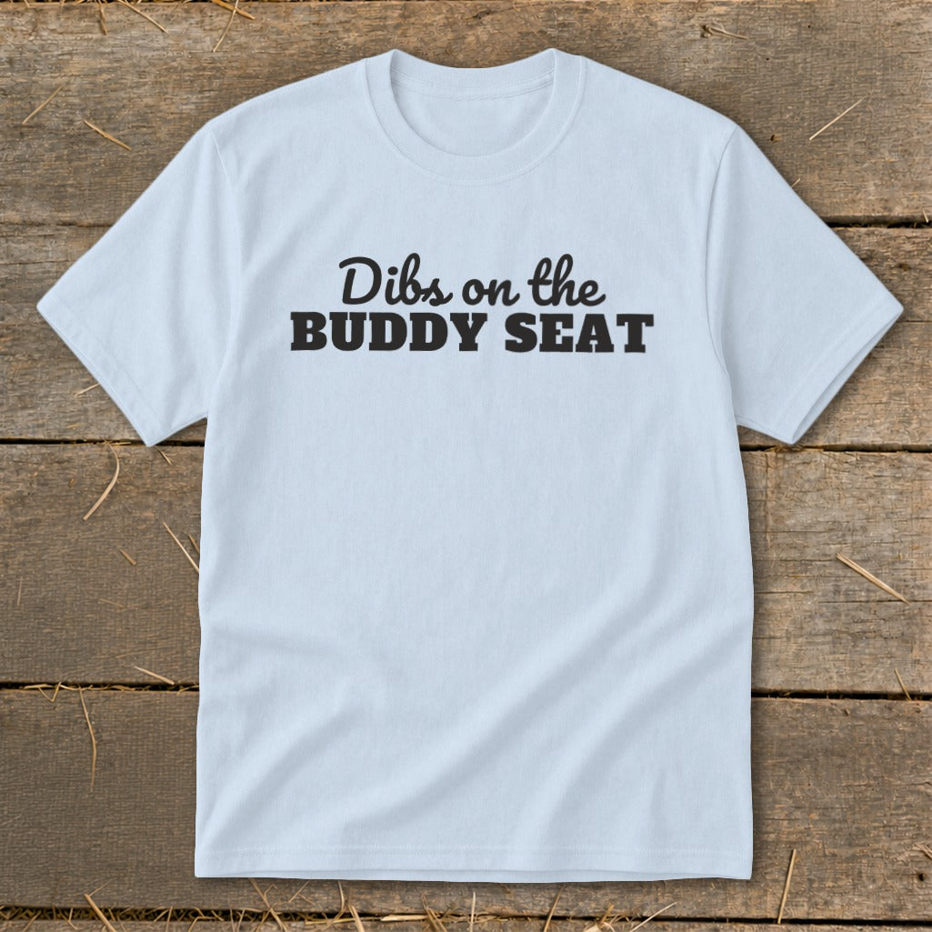 Light blue t-shirt with black text that reads "Dibs on the BUDDY SEAT".