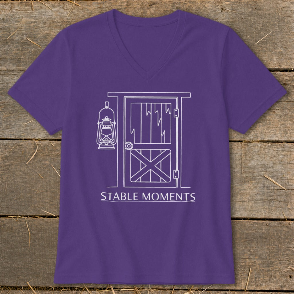 Purple v-neck t-shirt with white outline graphic of barn door, lantern, and text "STABLE MOMENTS".