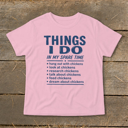 Pink t-shirt with "Things I Do In My Spare Time" and chicken-related activities.