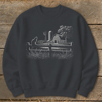 Cat sitting on fence with barn, windmill, and tree in the background.