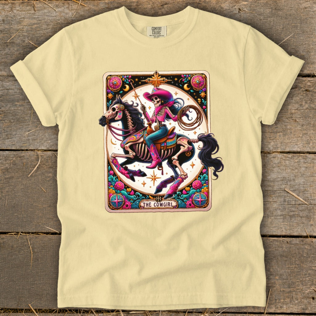 Skeleton cowgirl on horse, holding lasso, with text "THE COWGIRL".
