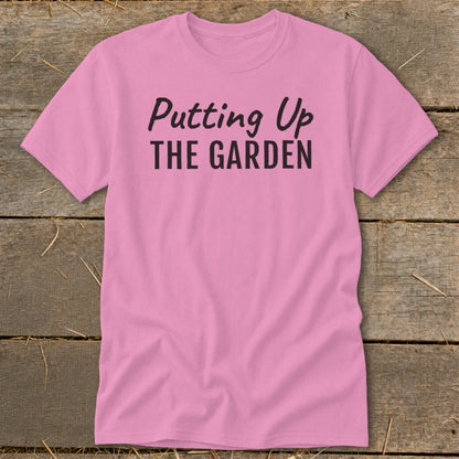Pink t-shirt with "Putting Up THE GARDEN" text in black.