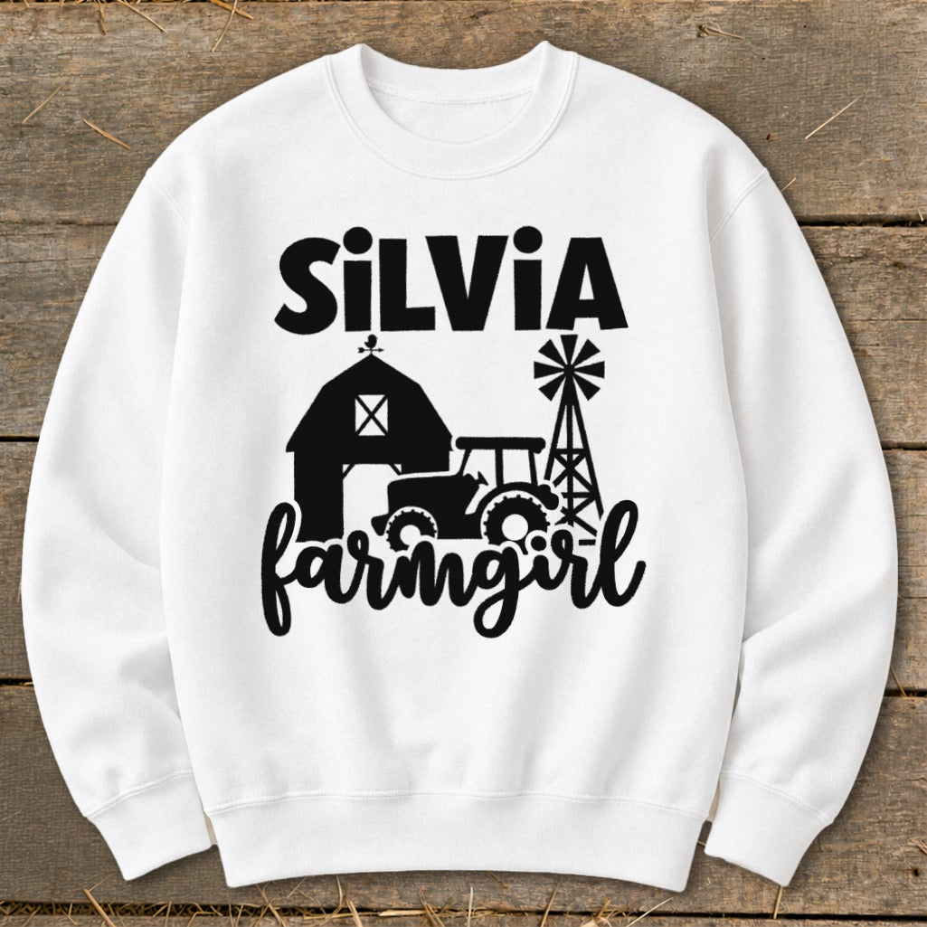 White sweatshirt with "Silvia Farmgirl" text and barn, tractor, windmill graphics.