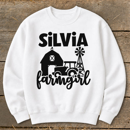 White sweatshirt with "Silvia Farmgirl" text and barn, tractor, windmill graphics.