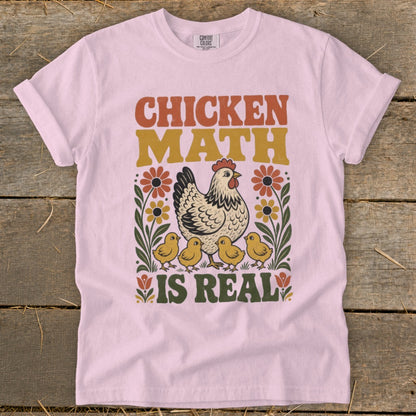 Pink t-shirt with "Chicken Math is Real" text, a hen, chicks, and flowers.