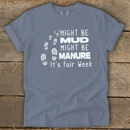 Gray t-shirt with white text: "Might be Mud, Might be Manure, It's Fair Week." Footprints graphic.