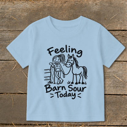 Light blue t-shirt with black text and drawing of girl with horse.