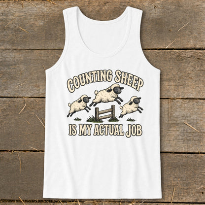White tank top with "Counting Sheep IS MY ACTUAL JOB" text and three sheep jumping over a fence.