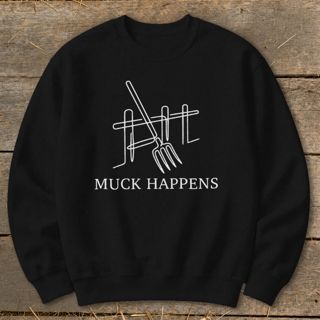 Black sweatshirt with white graphic of pitchfork and fence, and text "MUCK HAPPENS".