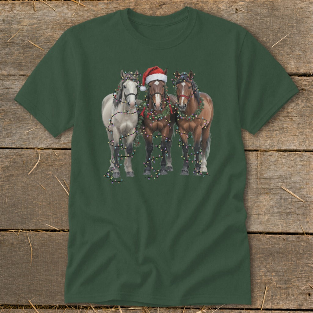 Three horses in festive garlands and Christmas lights, one wearing a Santa hat.