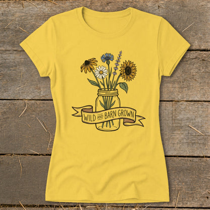 Yellow t-shirt with floral mason jar graphic and "WILD AND BARN GROWN" banner.