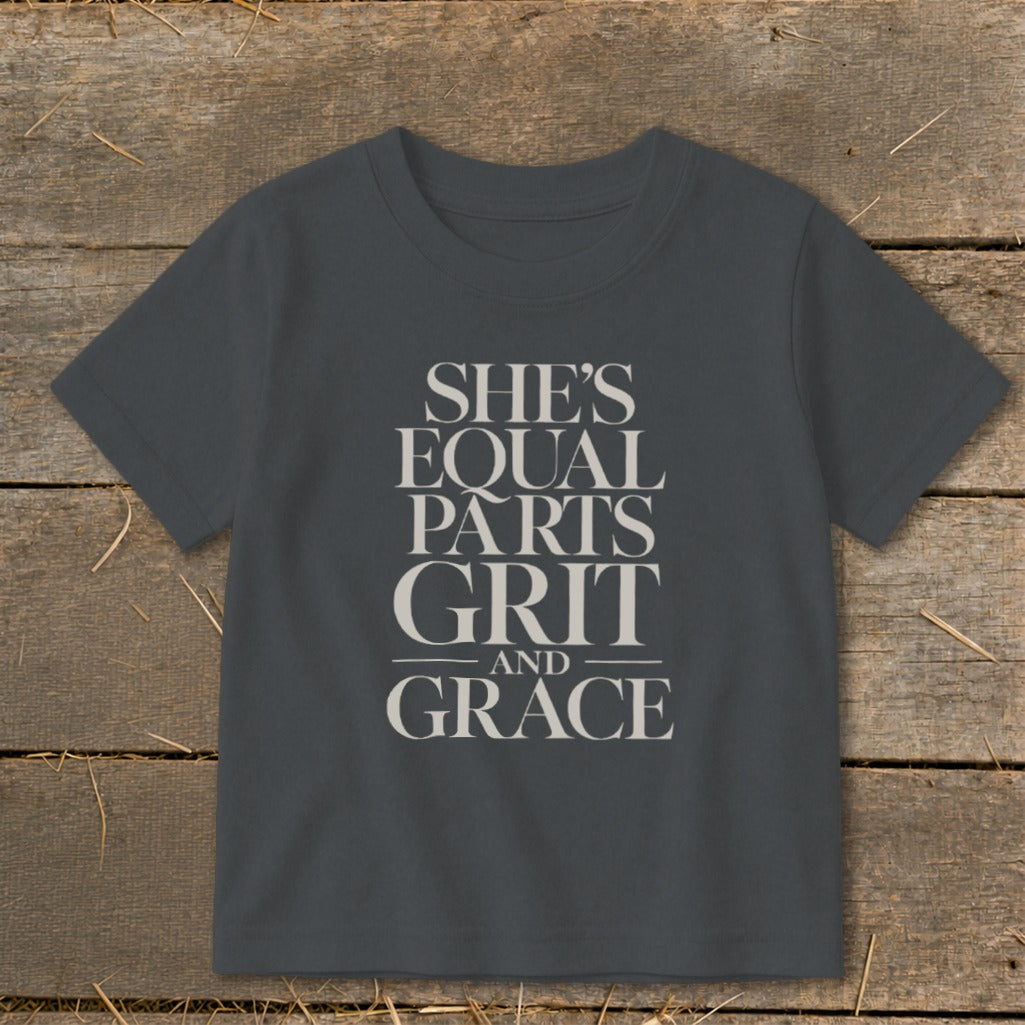 Gray t-shirt with text "SHE'S EQUAL PARTS GRIT AND GRACE"