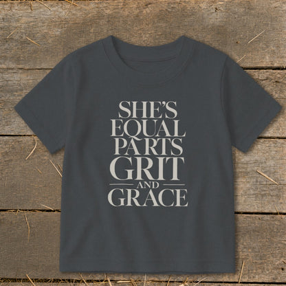 Gray t-shirt with text "SHE'S EQUAL PARTS GRIT AND GRACE"