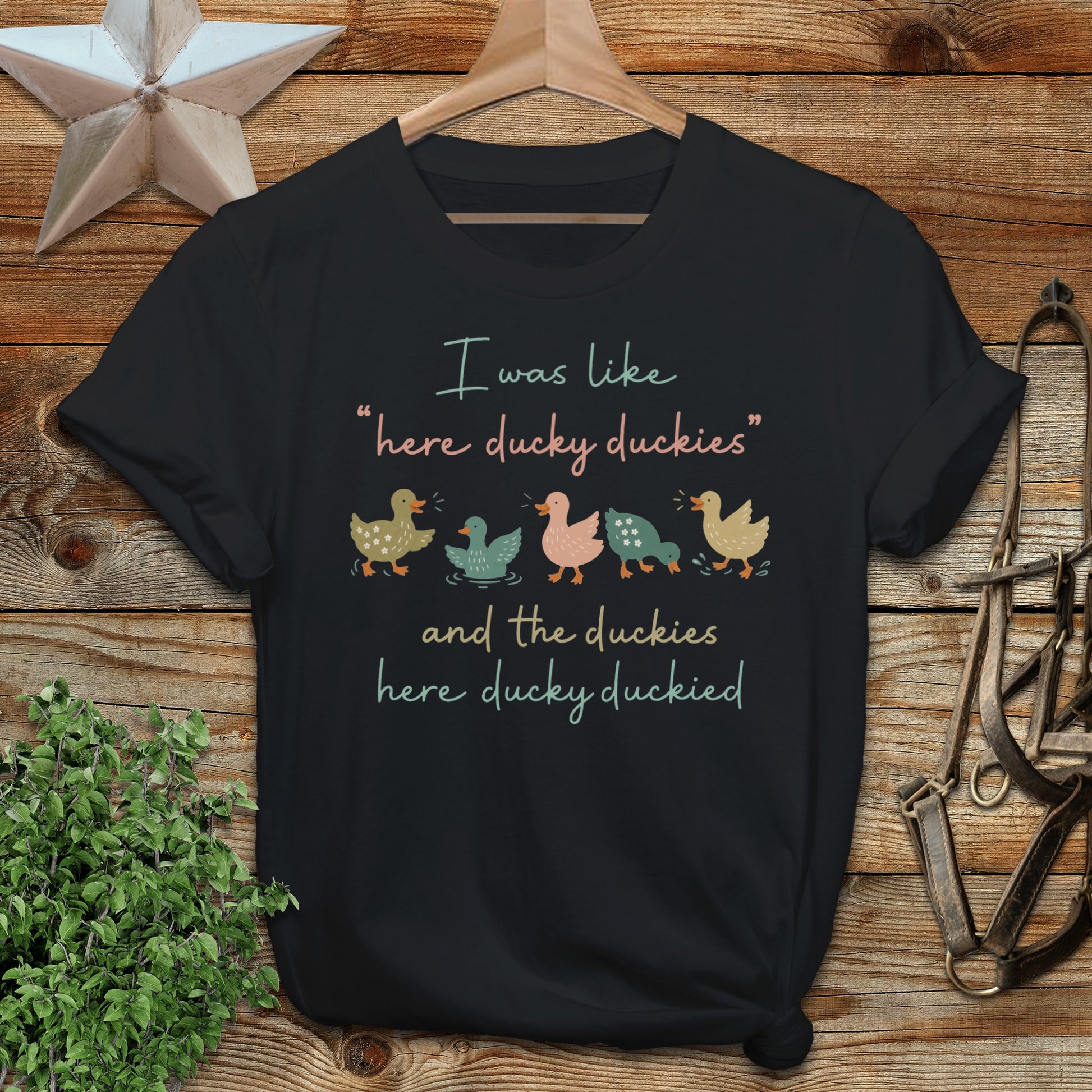 Black t-shirt with text and illustrations of ducks.