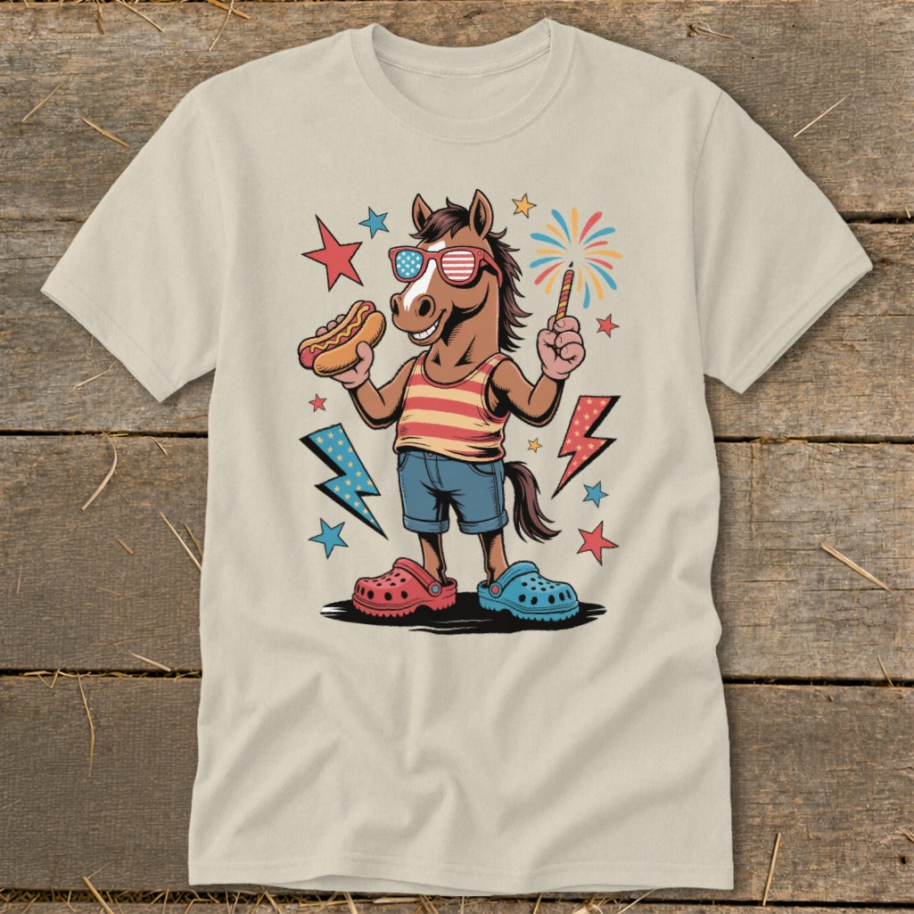 Cartoon horse in patriotic sunglasses holding hot dog and sparkler, wearing striped shirt and denim shorts.