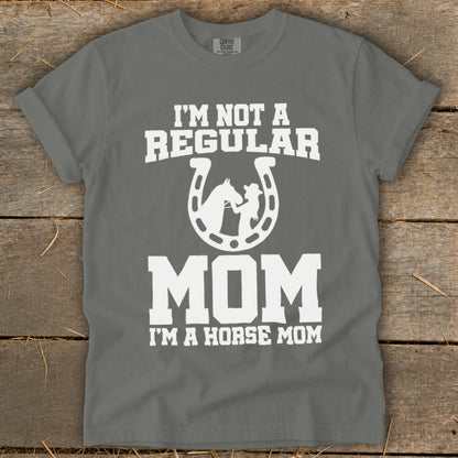 Grey t-shirt with white text "I'M NOT A REGULAR MOM I'M A HORSE MOM" and horseshoe graphic.