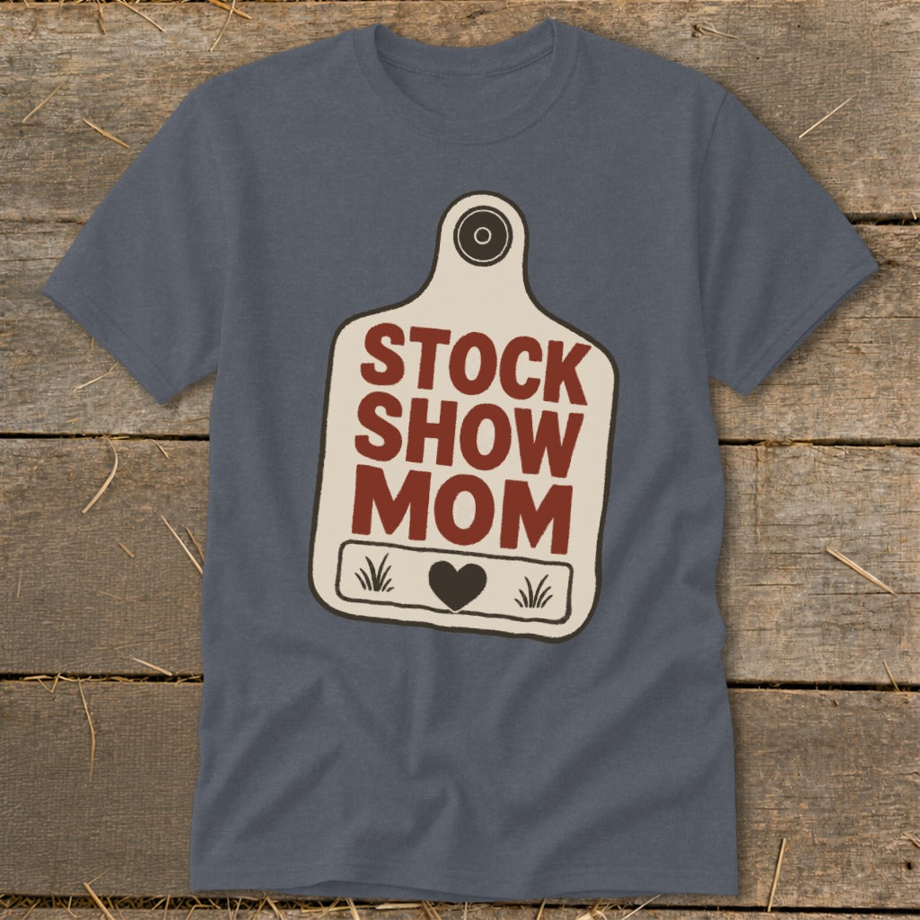 Blue t-shirt with "Stock Show Mom" text on a cow tag graphic.