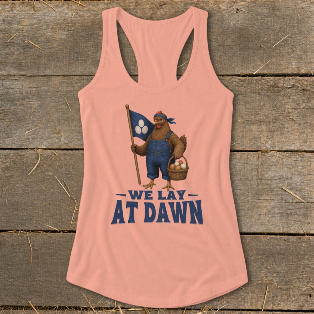 Peach tank top with chicken graphic holding flag and eggs, text reads "We Lay At Dawn".