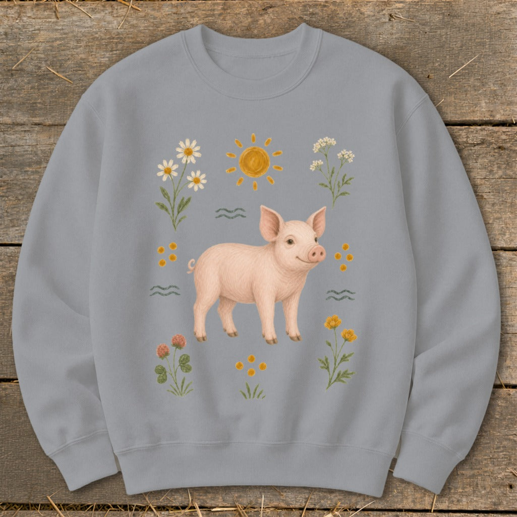 Light blue sweatshirt with a pig, sun, and flowers illustration.