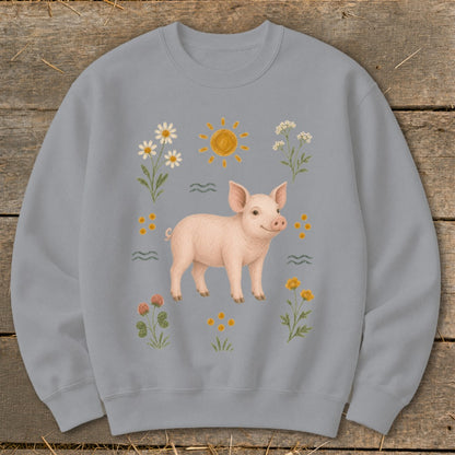 Light blue sweatshirt with a pig, sun, and flowers illustration.
