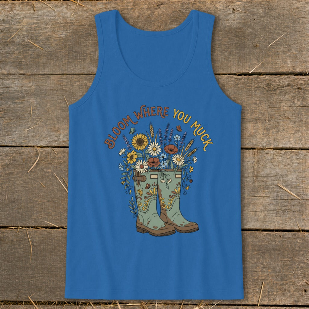 Blue tank top with "Bloom Where You Muck" text and floral boot graphic.