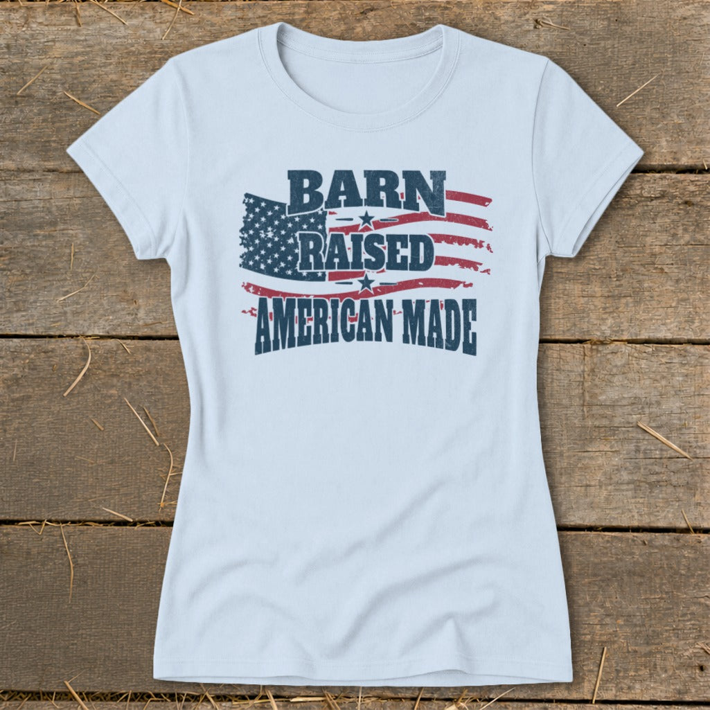 Light blue t-shirt with distressed "Barn Raised American Made" text and American flag graphic.