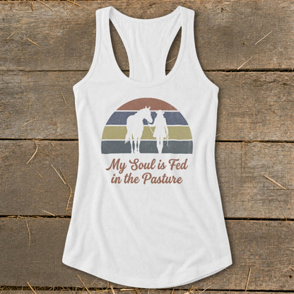 White tank top with horse and rider silhouette, "My Soul is Fed in the Pasture" text.