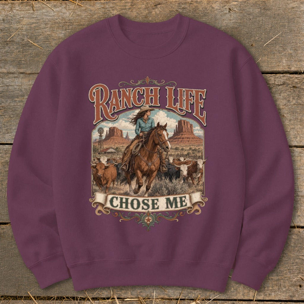 Crewneck sweatshirt with "Ranch Life Chose Me" graphic of a cowboy riding a horse and cattle.