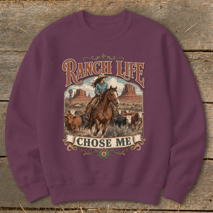 Crewneck sweatshirt with "Ranch Life Chose Me" graphic of a cowboy riding a horse and cattle.