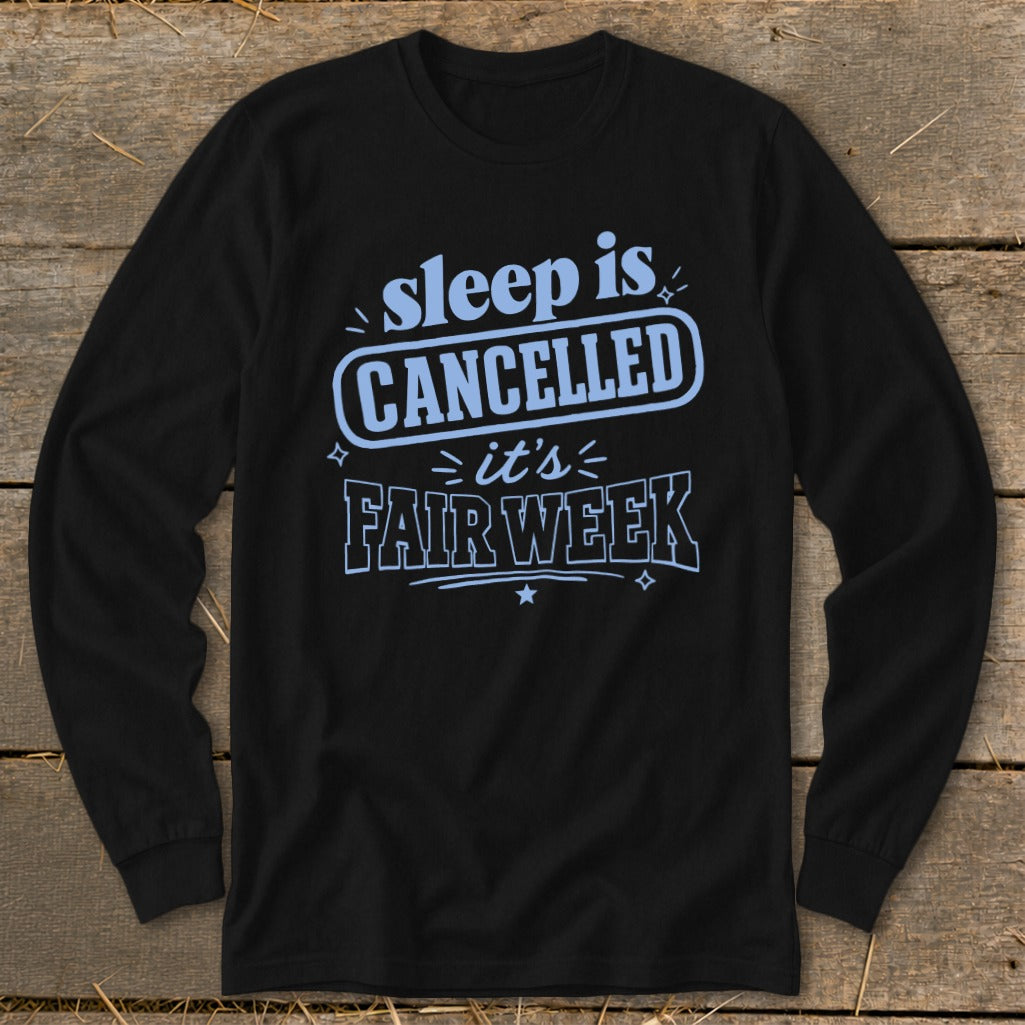 Black long sleeve shirt with light blue text that says "sleep is CANCELLED it's FAIR WEEK".