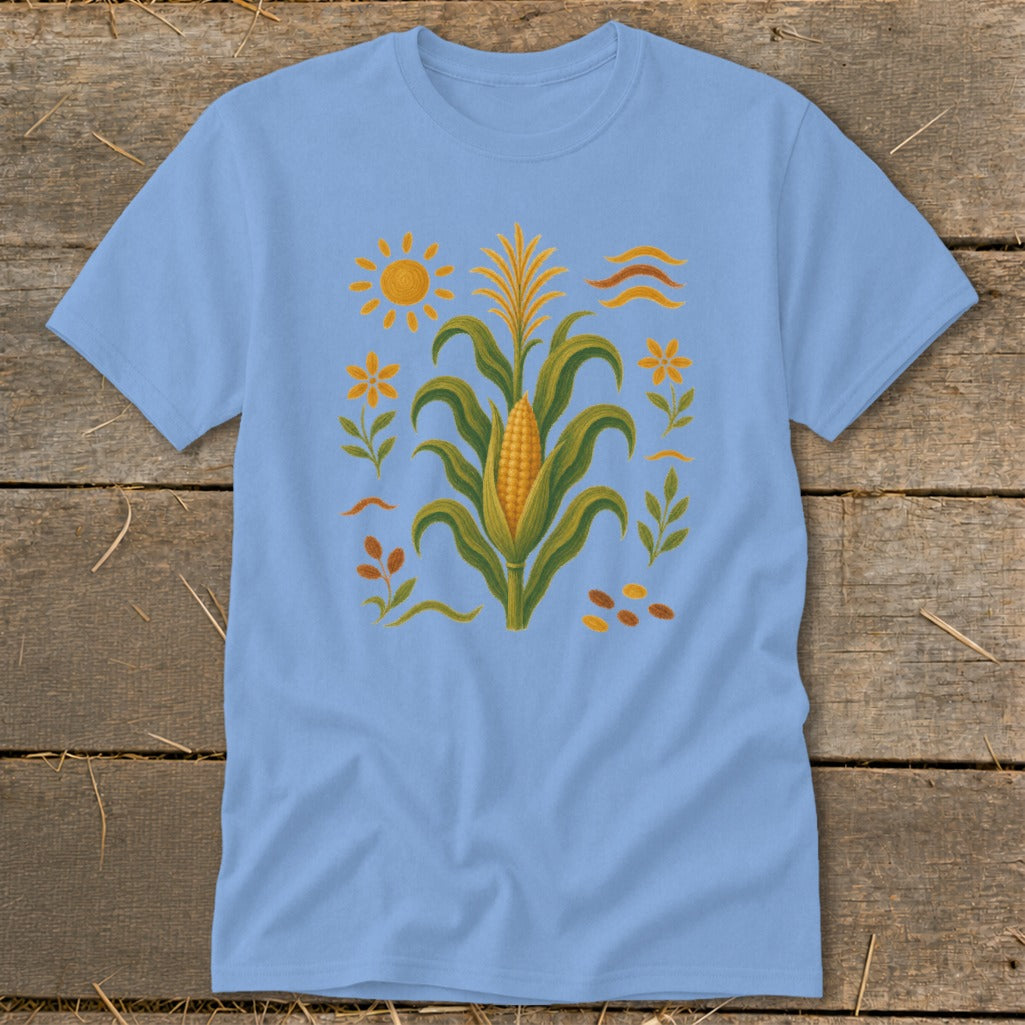 Light blue t-shirt with a corn stalk, sun, and floral design.