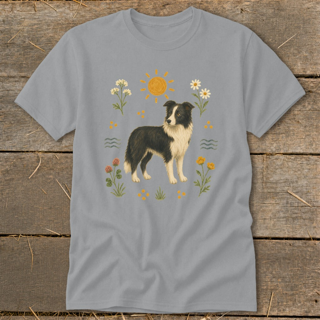 Border collie dog illustration surrounded by flowers, sun, and wavy lines on a grey t-shirt.