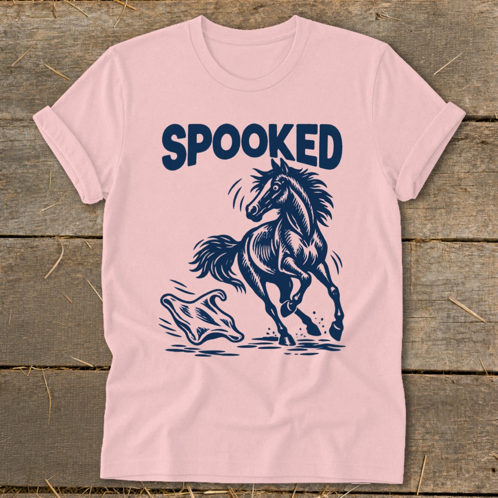 Pink t-shirt with a dark blue graphic of a startled horse and a ghost, with the word "SPOOKED".