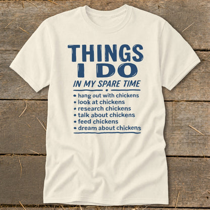 Cream t-shirt with blue text listing chicken-related activities.