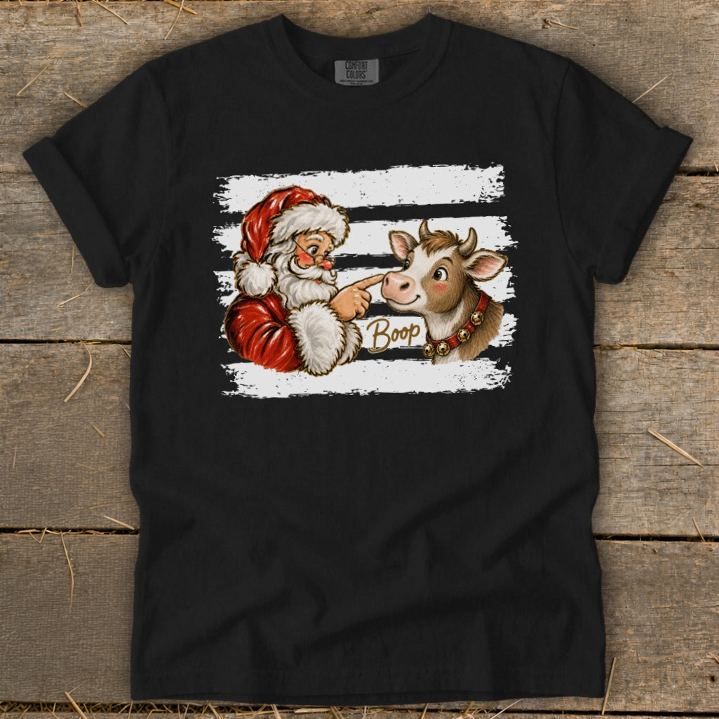 Santa booping a cow's nose with the word "Boop" on a t-shirt.