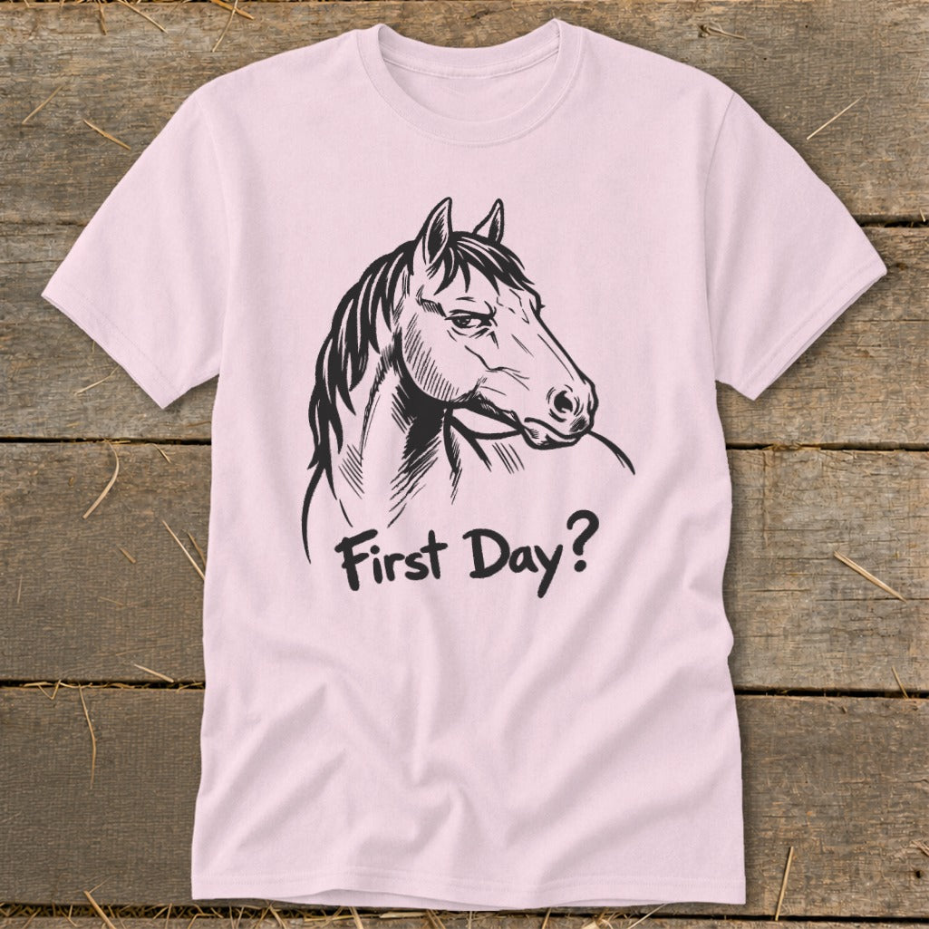 Pink t-shirt with black line art of a horse's head and text "First Day?".