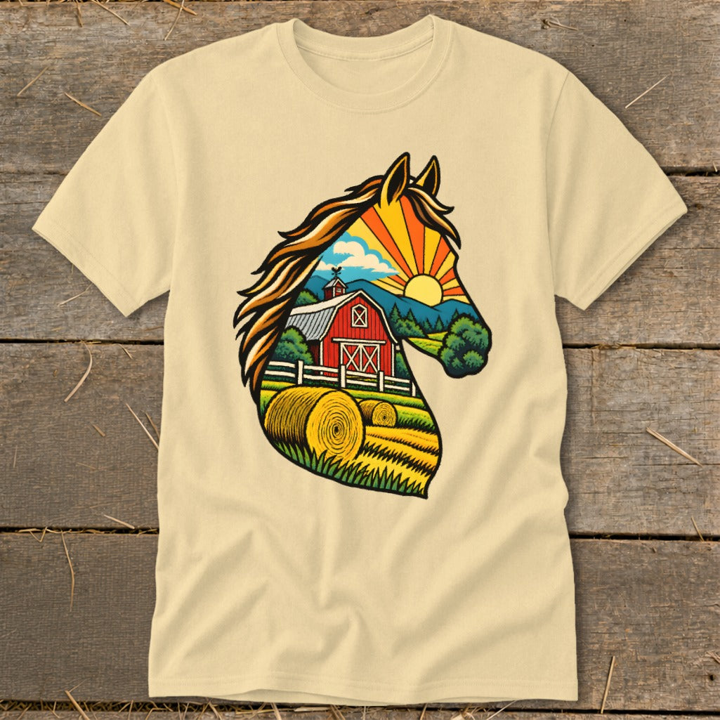 A cream-colored t-shirt with a colorful graphic of a horse head filled with a farm scene containing a red barn, hay bales, and a sunrise.