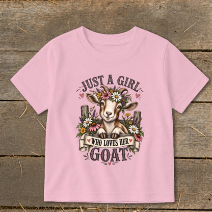 Pink t-shirt graphic with goat wearing flower crown and text "Just a girl who loves her goat".