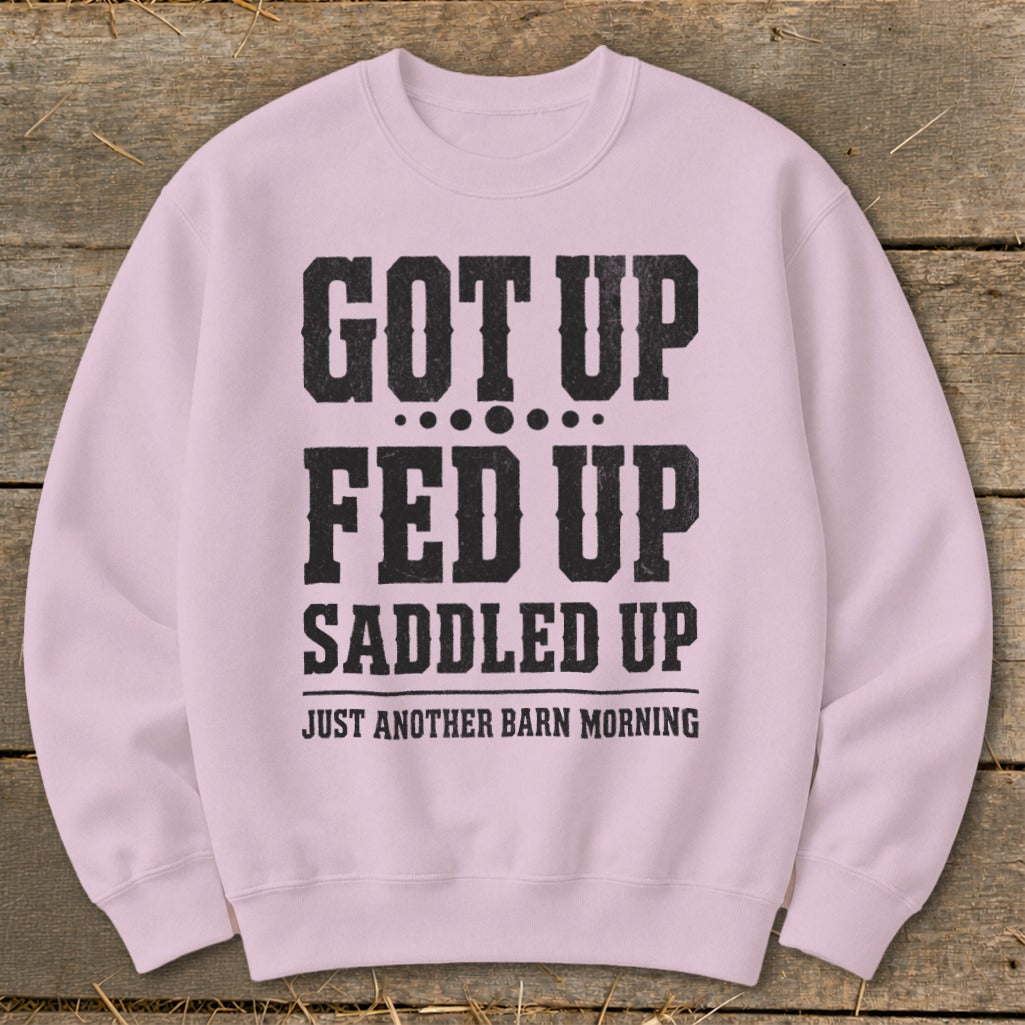Pink sweatshirt with black text reading "GOT UP FED UP SADDLED UP JUST ANOTHER BARN MORNING".