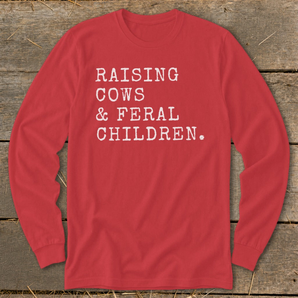 Red long-sleeve shirt with white text: "Raising Cows & Feral Children."