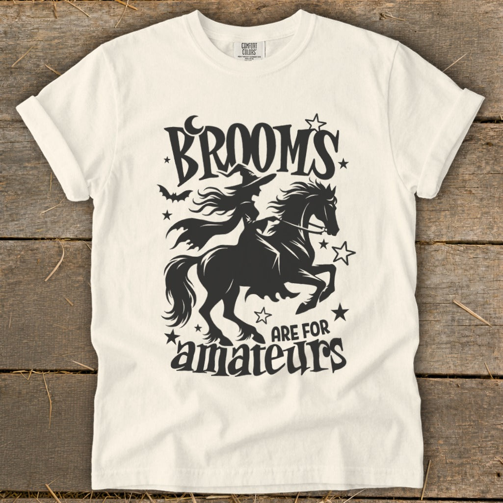 Black graphic of a witch riding a horse with text "Brooms are for amateurs"