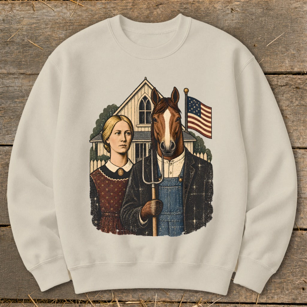 Cream-colored sweatshirt featuring a parody of American Gothic with a woman and a horse holding a pitchfork.