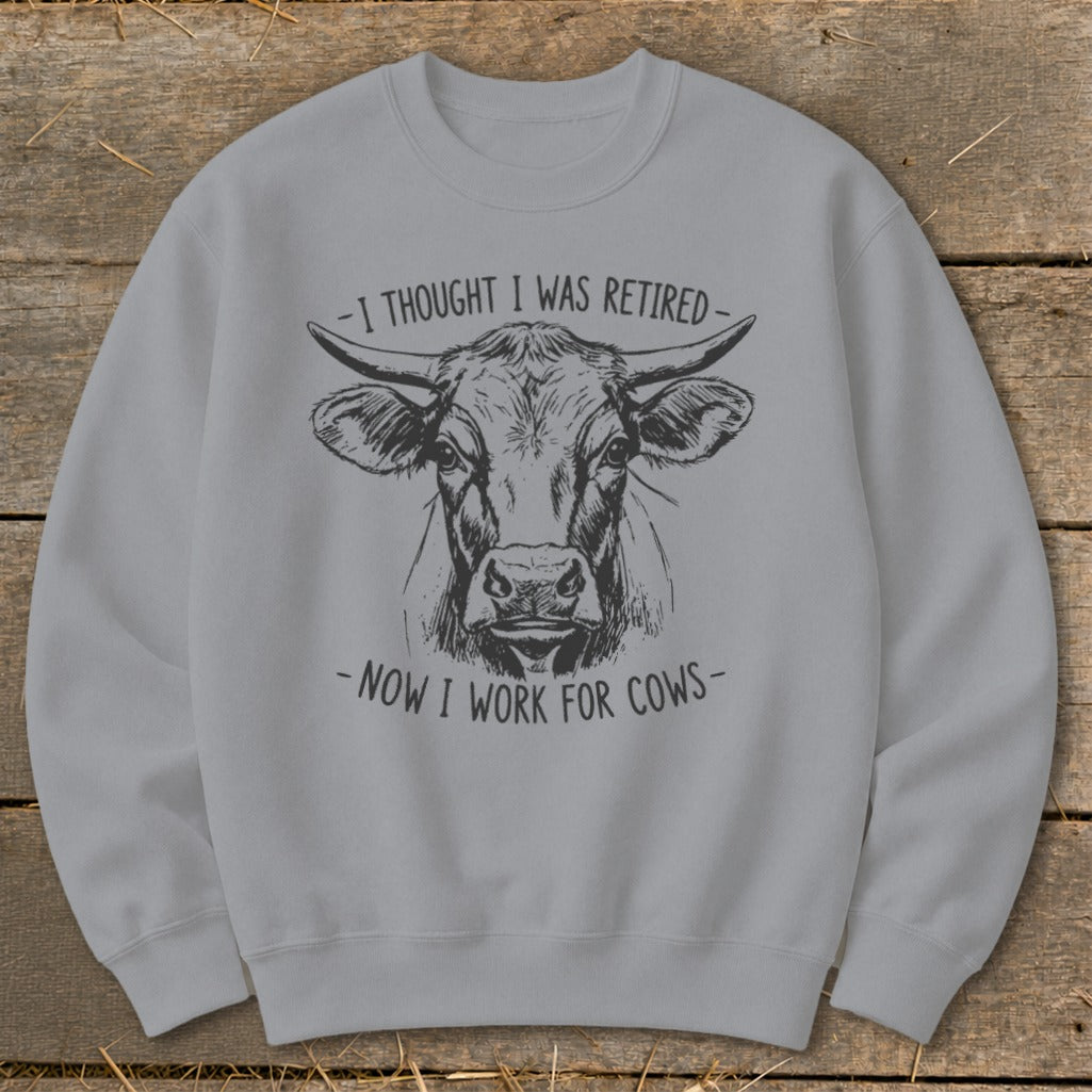 Light gray sweatshirt with a cow sketch and text "I thought I was retired - Now I work for cows".