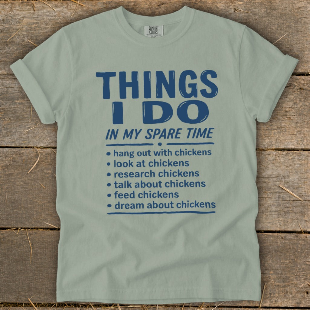 Light green t-shirt with blue text listing chicken-related activities.